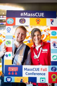 Administrative Assistant, Brendan Scott, and Marketing Manager, Veronica Reed pose for a photo with the MassCUE selfie frame